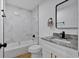 Bathroom with white marble-look shower tiles, granite vanity, and modern fixtures at 144 Cathy Ln, Hiram, GA 30141
