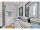 Bright bathroom with a double sink vanity, granite countertop, and modern fixtures at 144 Cathy Ln, Hiram, GA 30141