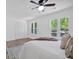 Bright bedroom with three windows, ceiling fan, and closet with paneled doors at 144 Cathy Ln, Hiram, GA 30141