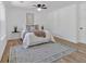 Bright bedroom features neutral decor, ceiling fan, and wood-look flooring at 144 Cathy Ln, Hiram, GA 30141