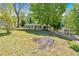 View of the front exterior with a partially landscaped yard and mature trees at 144 Cathy Ln, Hiram, GA 30141