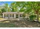 Charming front of home with black trim accents, landscaped yard and large windows at 144 Cathy Ln, Hiram, GA 30141