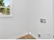 Functional laundry room with natural light, utility connections, and ample space at 144 Cathy Ln, Hiram, GA 30141