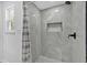 A modern walk-in shower with large marble-look tiles and built-in niche at 144 Cathy Ln, Hiram, GA 30141