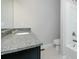 Bright bathroom featuring a granite vanity top and neutral decor at 247 Lotus Ln, Covington, GA 30016