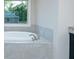Relaxing bathroom view with luxurious soaking tub and tiled surround at 247 Lotus Ln, Covington, GA 30016