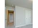 Bedroom with gray walls and carpet, featuring interior doors and views to the hallway at 247 Lotus Ln, Covington, GA 30016