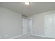 Neutral bedroom featuring gray walls, carpet flooring, and a white interior door at 247 Lotus Ln, Covington, GA 30016