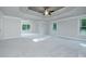 Expansive bedroom with tray ceiling, ceiling fan and multiple windows at 247 Lotus Ln, Covington, GA 30016
