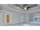 Large bedroom boasts a tray ceiling, ceiling fan, and ample natural light at 247 Lotus Ln, Covington, GA 30016