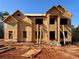 Unfinished two-story house with wood framing and a blue sky in the background at 247 Lotus Ln, Covington, GA 30016