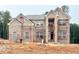 New two-story brick home featuring a classic design and large windows, currently under construction at 247 Lotus Ln, Covington, GA 30016