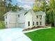 Beautiful home with a three-car garage, green lawn, and elegant landscaping at 247 Lotus Ln, Covington, GA 30016