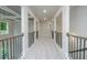 Hallway with carpet, rod iron railing and view of the bedrooms at 247 Lotus Ln, Covington, GA 30016