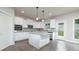 Modern kitchen boasts white cabinets, granite countertops, stainless steel appliances, and a large island at 247 Lotus Ln, Covington, GA 30016