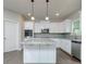 Well-equipped kitchen with a central island, stainless steel appliances, and a stylish gray backsplash at 247 Lotus Ln, Covington, GA 30016