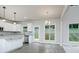 Bright, open kitchen featuring white cabinets, granite countertops, and stainless steel appliances at 247 Lotus Ln, Covington, GA 30016