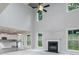 Open-concept living room with fireplace and large windows showcasing backyard at 247 Lotus Ln, Covington, GA 30016