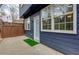 Exterior view of a home with dark siding, a white door, and a fenced-in patio area at 2700 Ridge Run Tr Trl, Duluth, GA 30097