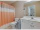 Bright bathroom with a white vanity, toilet, and shower with a striped curtain at 2700 Ridge Run Tr Trl, Duluth, GA 30097