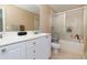 Bathroom features a dual vanity, tub, and shower combo with a sliding glass door at 2700 Ridge Run Tr Trl, Duluth, GA 30097