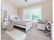 Cozy bedroom with a white bed frame, desk, and large window for ample natural light at 2700 Ridge Run Tr Trl, Duluth, GA 30097