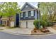 Charming two-story home with a two-car garage and beautifully landscaped front yard with blue siding and black shutters at 2700 Ridge Run Tr Trl, Duluth, GA 30097