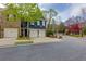 Beautiful curb appeal, featuring a two-car garage, lush green lawn, and mature trees in a peaceful neighborhood at 2700 Ridge Run Tr Trl, Duluth, GA 30097