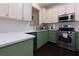 Well-lit kitchen with green cabinets, stainless steel appliances, and a quartz countertop at 2700 Ridge Run Tr Trl, Duluth, GA 30097