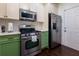 A well-equipped kitchen with stainless steel appliances and stylish green cabinetry at 2700 Ridge Run Tr Trl, Duluth, GA 30097