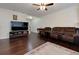 Large living room with hardwood floors, cozy furnishings, and modern entertainment setup with plenty of light at 2700 Ridge Run Tr Trl, Duluth, GA 30097