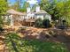Expansive backyard with a deck, lush lawn, mature trees and a trampoline, perfect for recreation and outdoor enjoyment at 300 Brayward Chase, Roswell, GA 30076