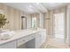 Elegant bathroom with double vanity, neutral striped wallpaper, and plenty of counter space, offering style and functionality at 300 Brayward Chase, Roswell, GA 30076