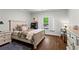 Bedroom featuring a bed with baseball-themed pillows, a nightstand, a desk and a hardwood floor at 300 Brayward Chase, Roswell, GA 30076