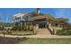 Exterior view of the clubhouse featuring a patio, stone accents, and landscaped grounds, showcasing community amenities at 300 Brayward Chase, Roswell, GA 30076