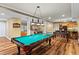 Spacious game room featuring a pool table, foosball, bar area, and comfortable seating, perfect for entertaining at 300 Brayward Chase, Roswell, GA 30076