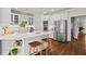 Bright kitchen featuring white cabinets, stainless steel appliances, an island with bar seating, and hardwood floors at 300 Brayward Chase, Roswell, GA 30076
