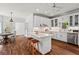 Bright kitchen with white cabinets, stainless steel appliances, a center island and adjacent breakfast area at 300 Brayward Chase, Roswell, GA 30076