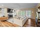 Bright and airy living room featuring hardwood floors, a fireplace, built-in shelves and a large couch at 300 Brayward Chase, Roswell, GA 30076