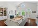 Bright living room with high ceilings, built-in bookshelves, and large windows overlooking the backyard at 300 Brayward Chase, Roswell, GA 30076