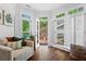 Bright sitting room featuring shuttered windows and a cozy sofa at 300 Brayward Chase, Roswell, GA 30076