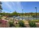 Beautifully landscaped tennis courts feature seating, manicured shrubs, and plenty of room for spectators at 300 Brayward Chase, Roswell, GA 30076