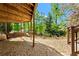 Cozy under-deck area with a swing, offering a shaded retreat with a view of the surrounding landscaped backyard at 300 Brayward Chase, Roswell, GA 30076