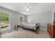 Bright bedroom with a view of the outside, a ceiling fan, and hardwood furniture at 6500 Chickasaw Dr, Douglasville, GA 30135