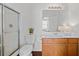 Bathroom featuring a glass-door shower, toilet, and vanity with ample lighting at 1228 W Oaks Way, Woodstock, GA 30188