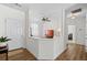 Inviting foyer featuring hardwood floors, white wainscoting, and an open view to the living area at 1228 W Oaks Way, Woodstock, GA 30188