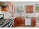 Contemporary kitchen with stainless steel appliances and natural light at 1228 W Oaks Way, Woodstock, GA 30188