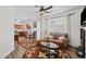 Comfortable living room with adjacent kitchen and dining, featuring a ceiling fan at 1228 W Oaks Way, Woodstock, GA 30188
