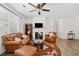 Relaxing living room with a fireplace, decor, and ample natural light at 1228 W Oaks Way, Woodstock, GA 30188