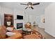 Inviting living room with a fireplace, ceiling fan and stylish decor at 1228 W Oaks Way, Woodstock, GA 30188